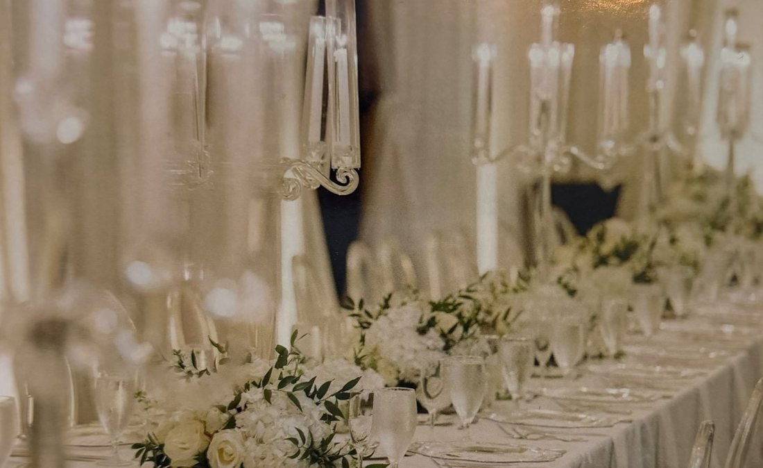 Long wedding table with crystal candelabras and white floral centerpieces by Lizbeth Designs & Events