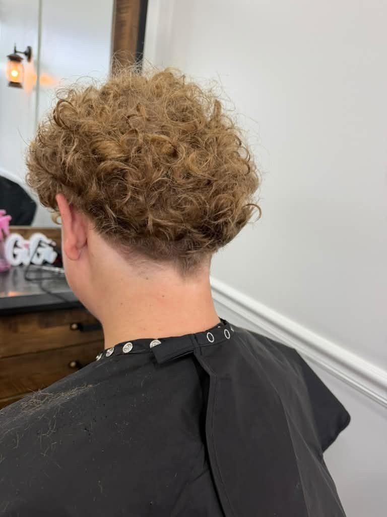 Men's curly cut with a clean taper